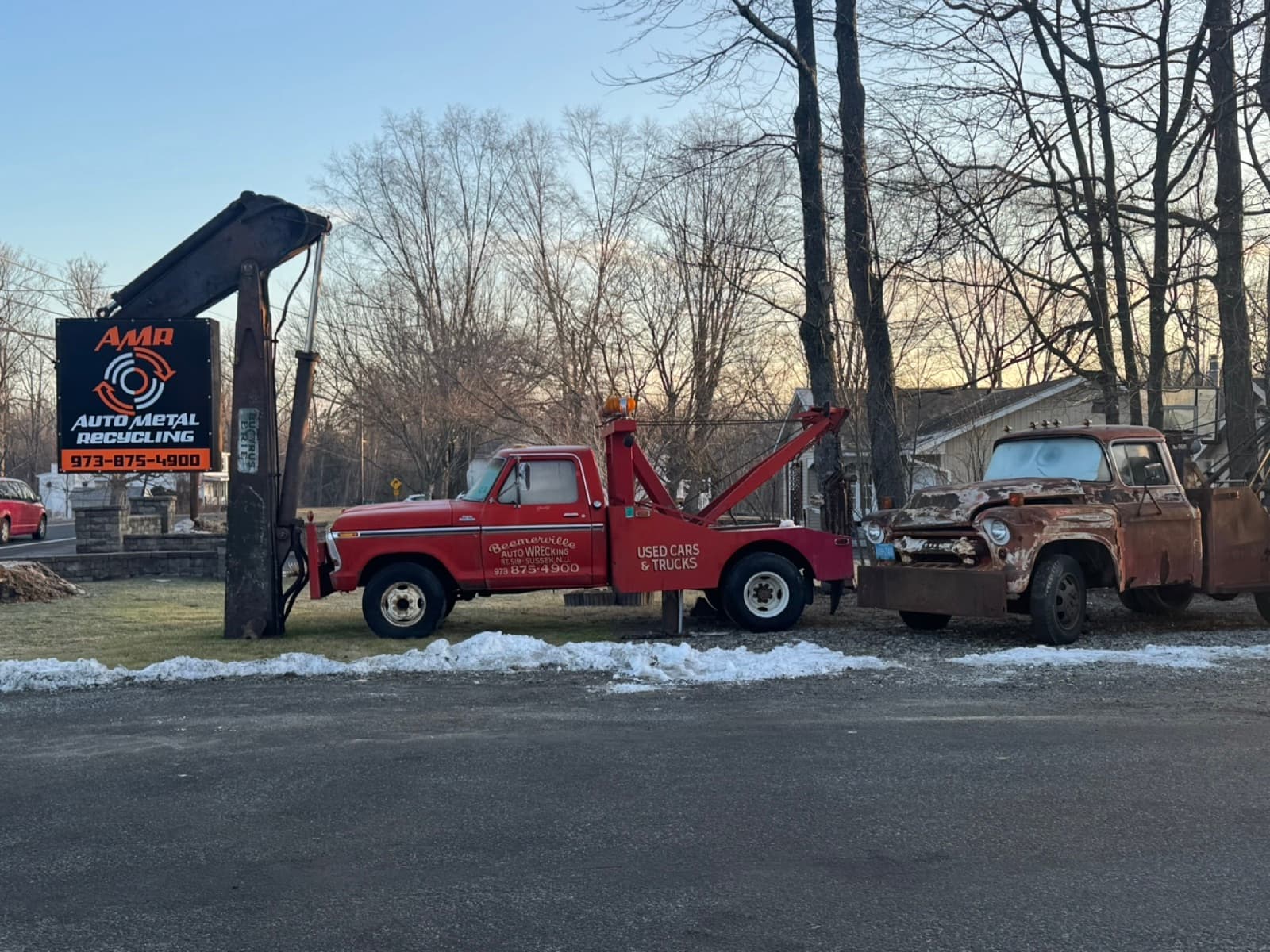 The AMR sign beside the original red Beemerville Auto Wrecking tow truck and a vintage pickup