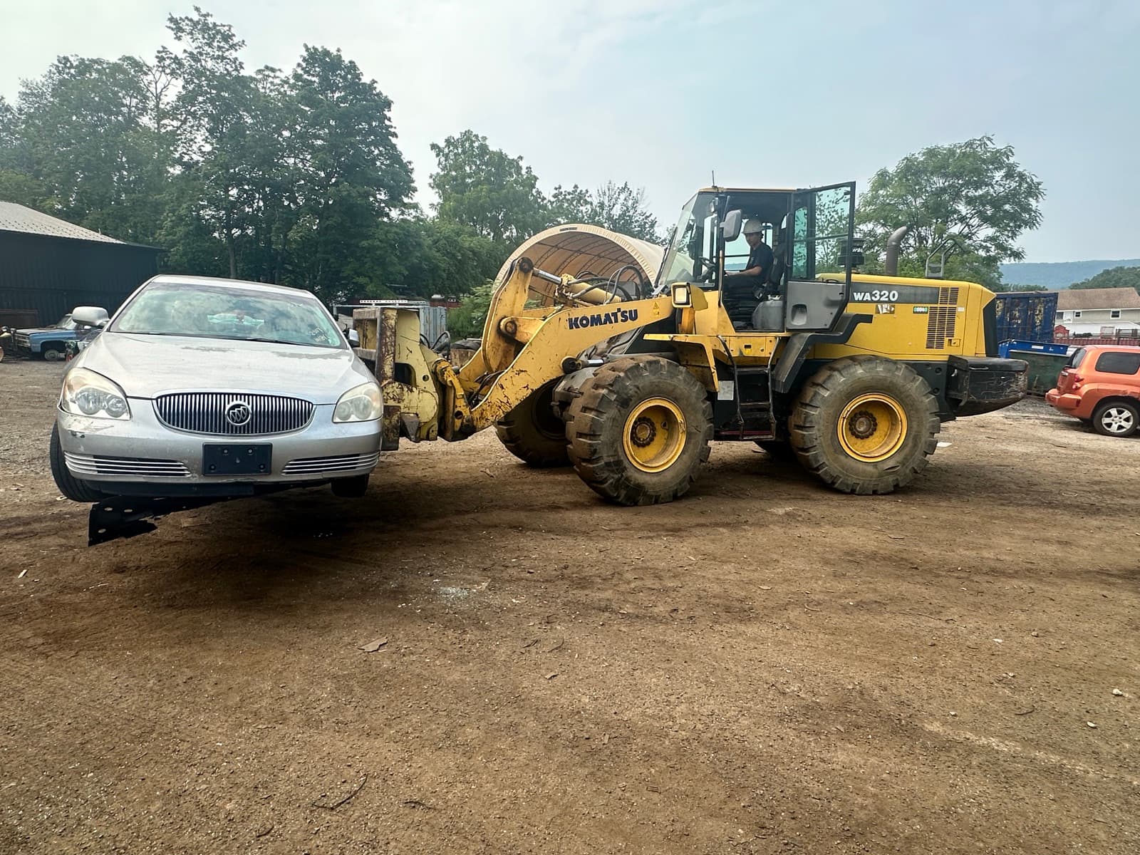 AMR's loader lifting a junk car that can no longer move on its own