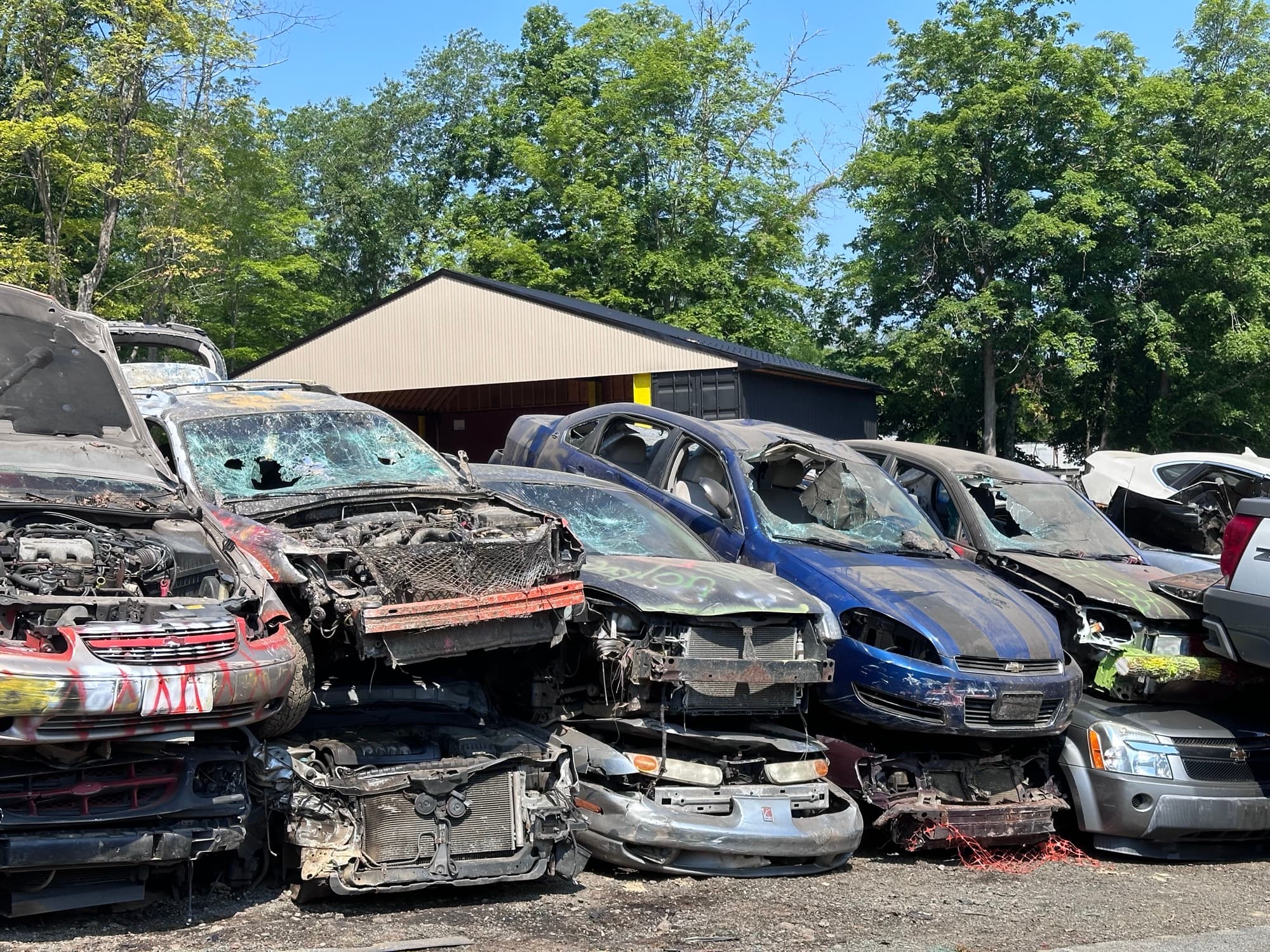 Rows of wrecked and crushed cars stacked at the AMR yard