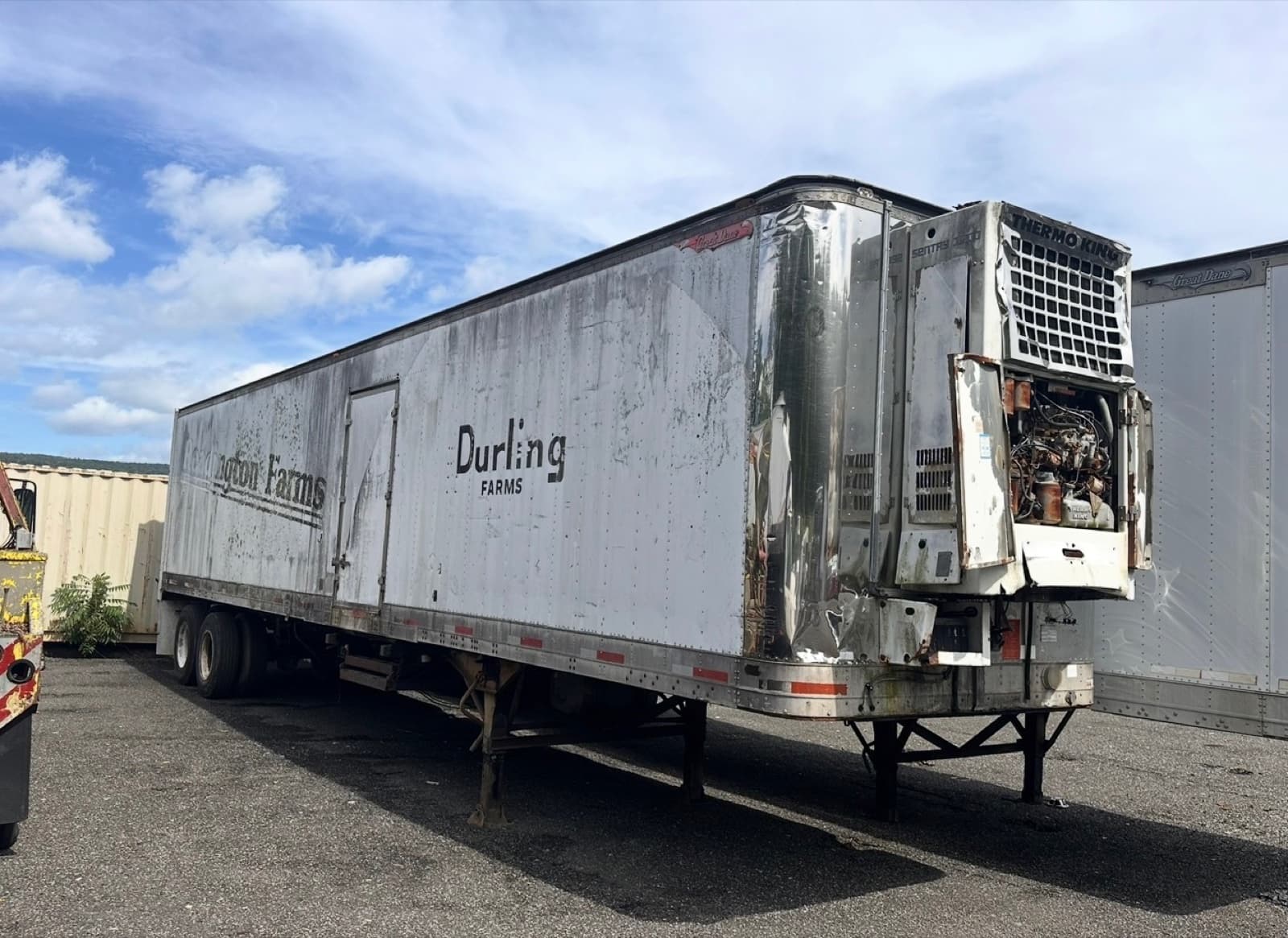 A retired refrigerated trailer with its cooling unit stripped, waiting to be recycled at the AMR yard